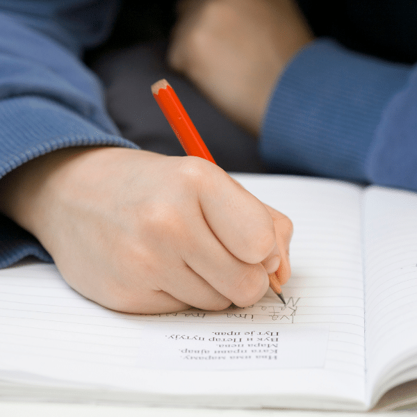 child writing conjunction sentences